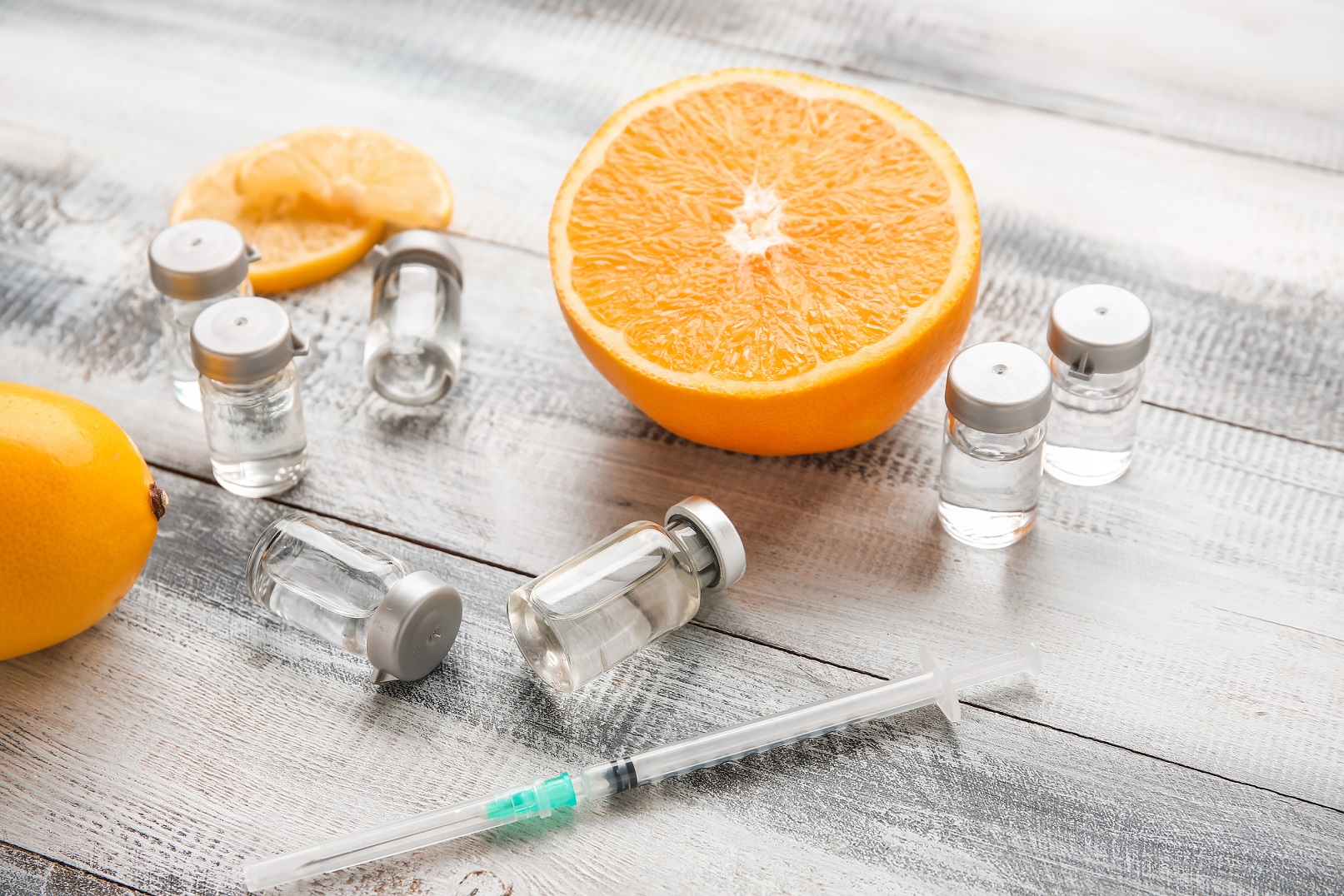 Ampules with vitamin C, syringe and citrus fruits on wooden background | Citidrips in Wilmington, DE