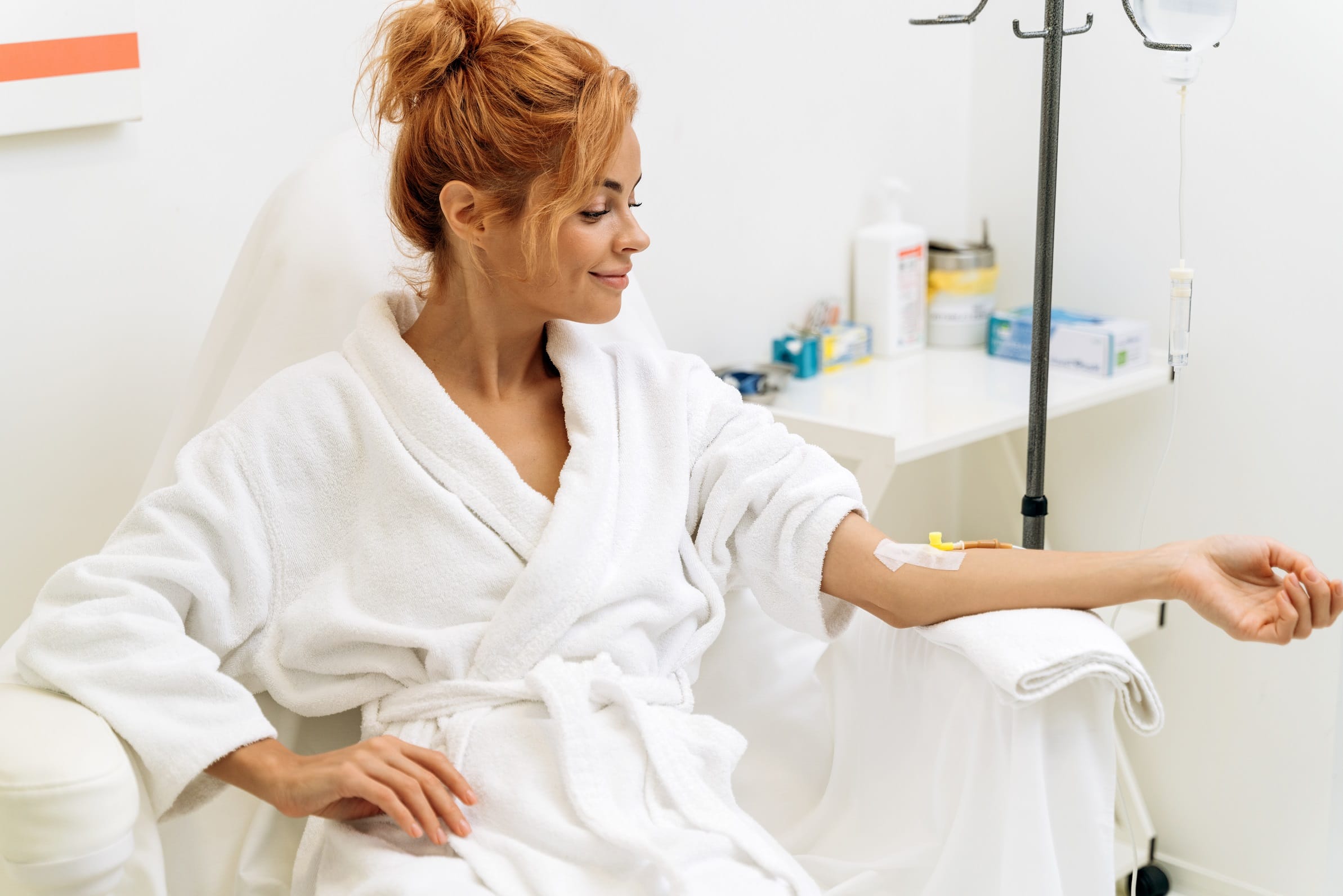 Portrait of mindful woman sitting in armchair and closed eyes while receiving IV infusion with vitamins | Citidrips in Wilmington, DE